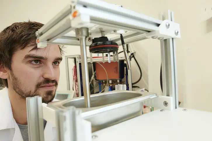 Member of Aseptium staff looks at company equipment