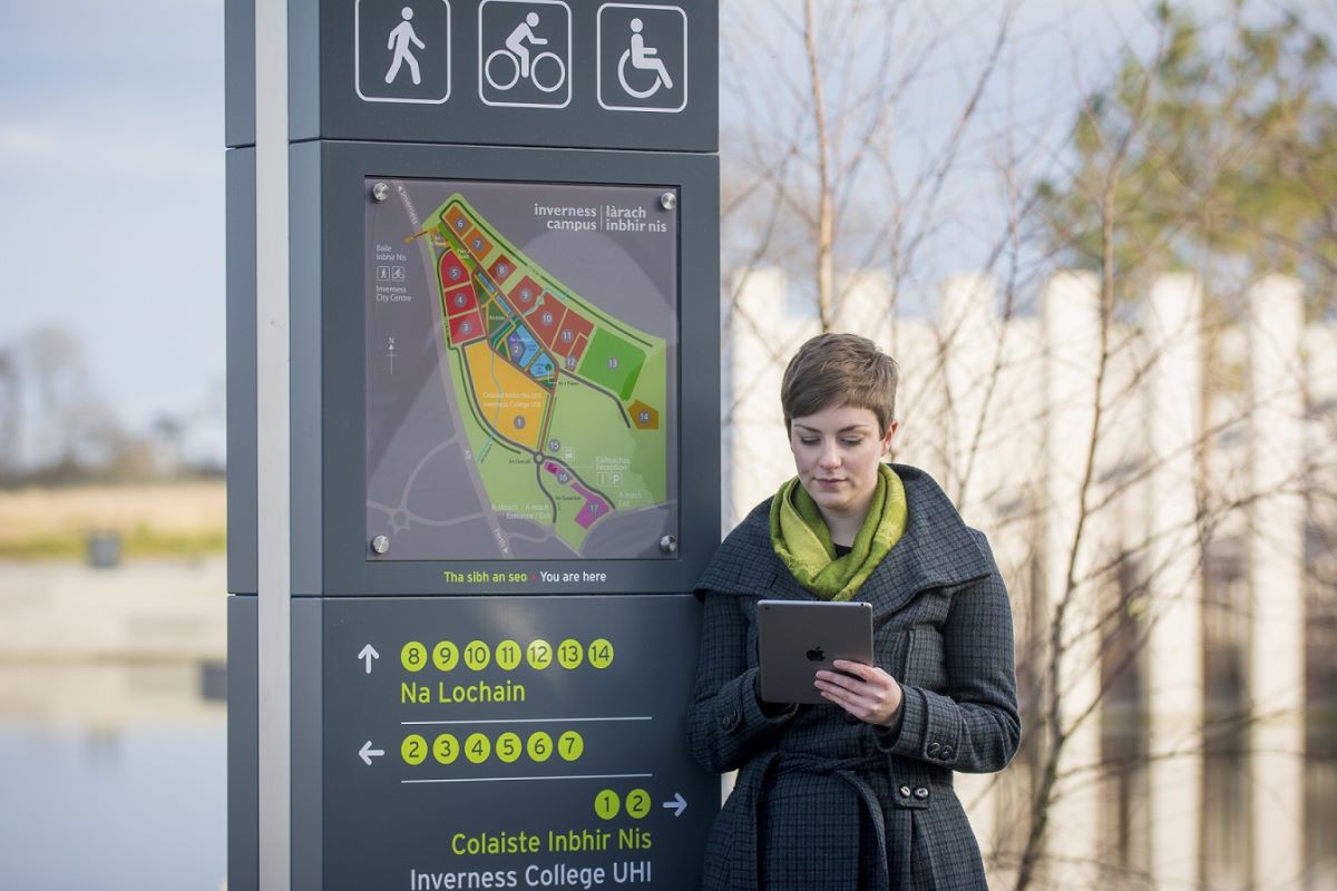 Girl beside orientation point on Inverness Campus