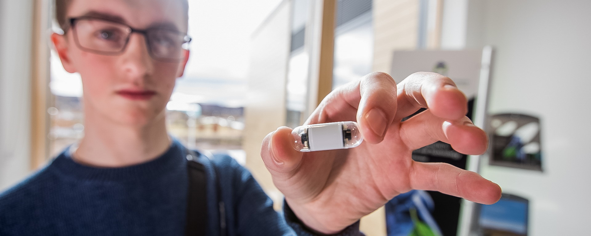 Staff member holding CorporateHealth International pillcam