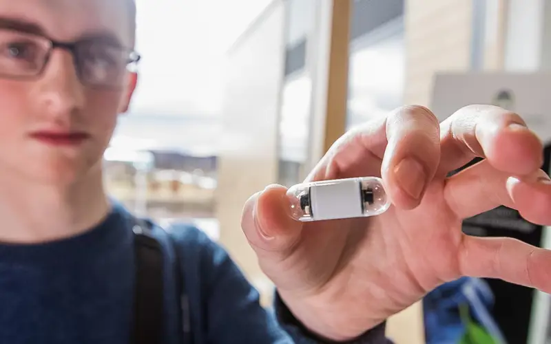 Staff member holding CorporateHealth International pillcam